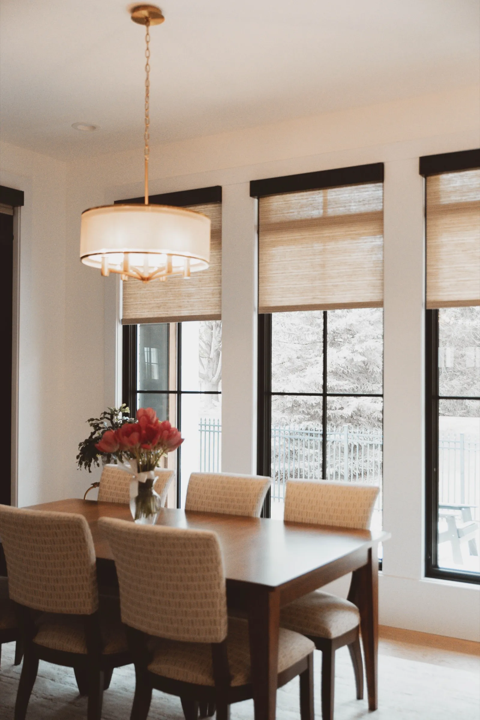 Dining room with woven wood shades