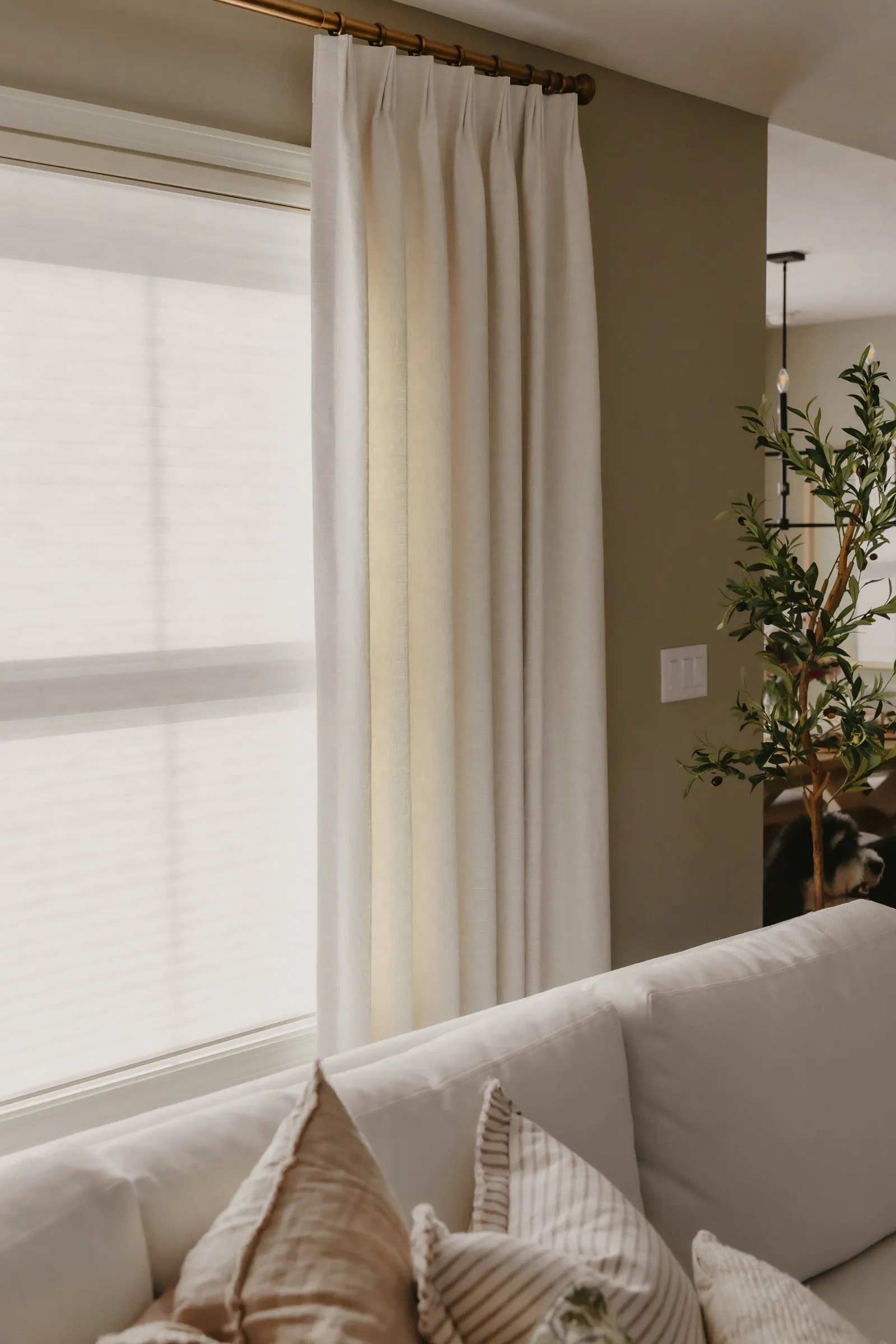 Living room with custom white drapery panels